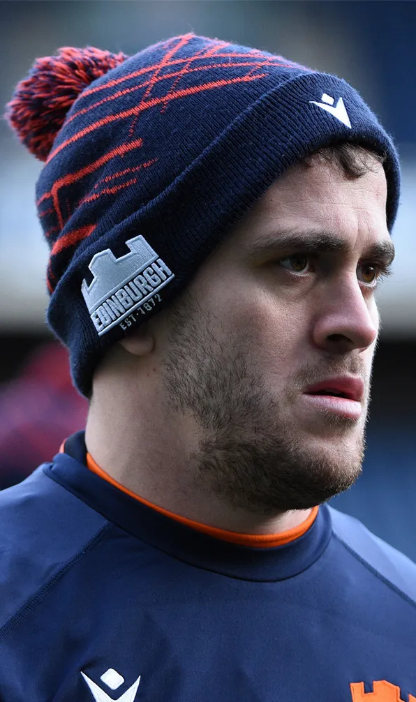 Edinburgh male rugby player wearing a beanie hat