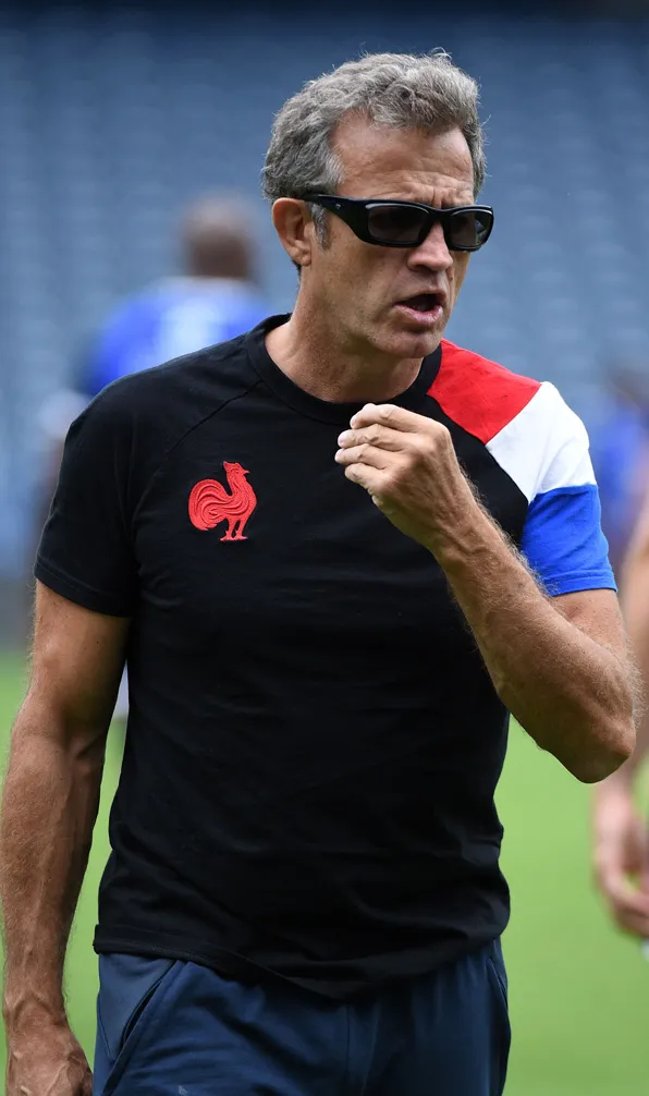 Man wearing a France rugby t-shirt with the stadium in the background