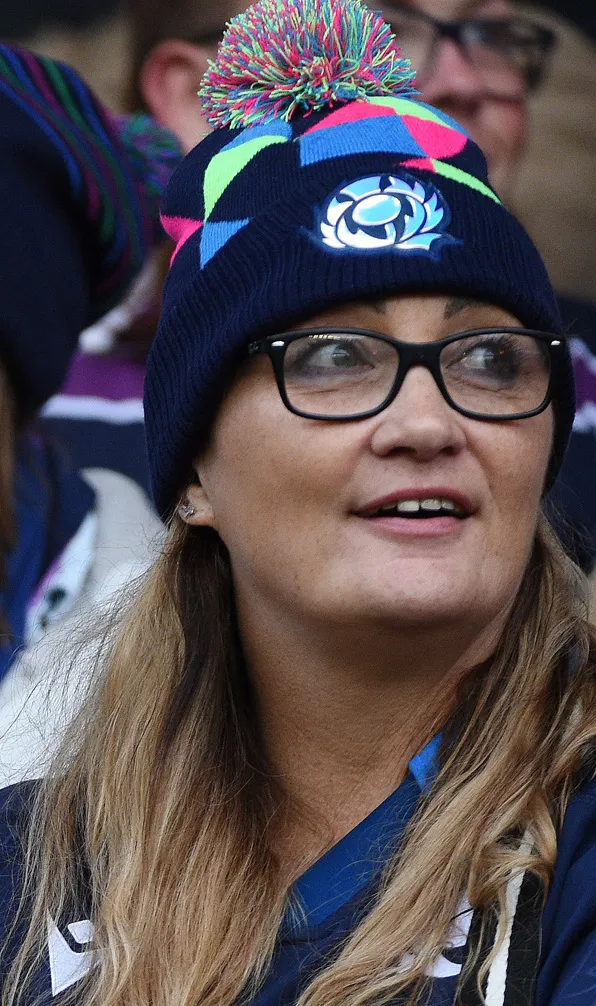 Hats & Scarfs Scotland supporter proudly shows the sRU thistle on her beanie hat