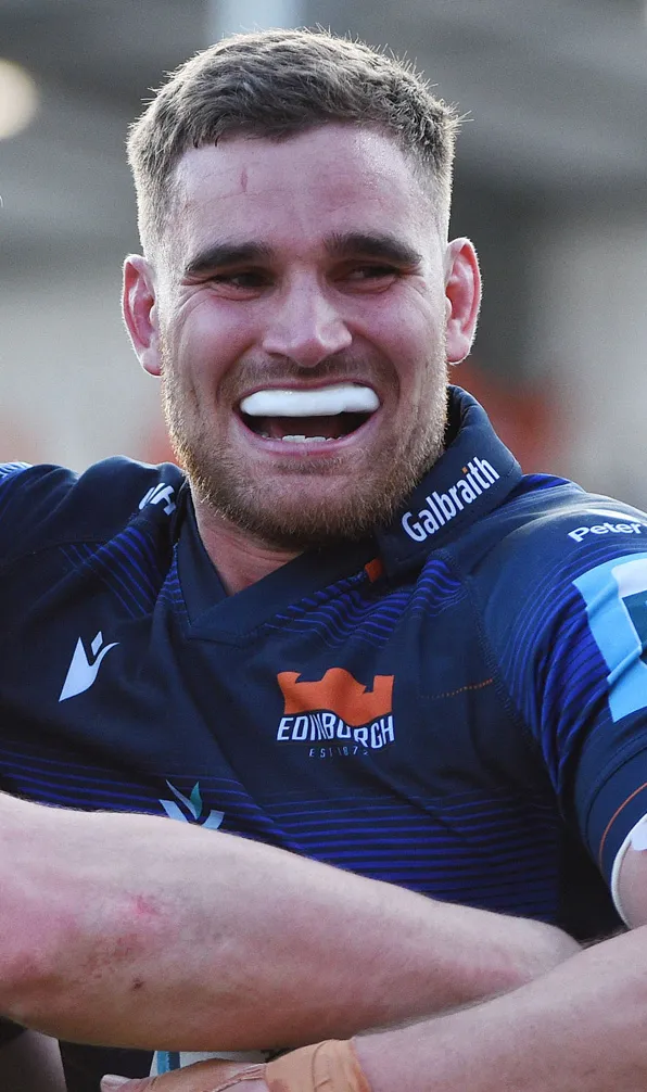 Male rugby player celebrating whilst wearing his mouthguard