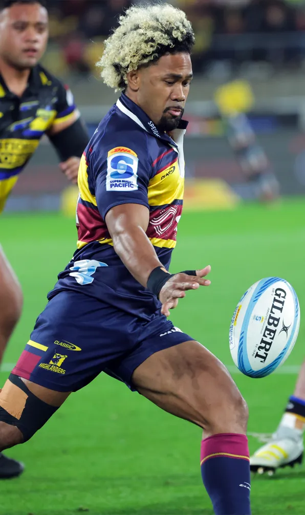 Shop Highlanders Now Highlanders player attempts a grubber kick whilst player Hurricanes